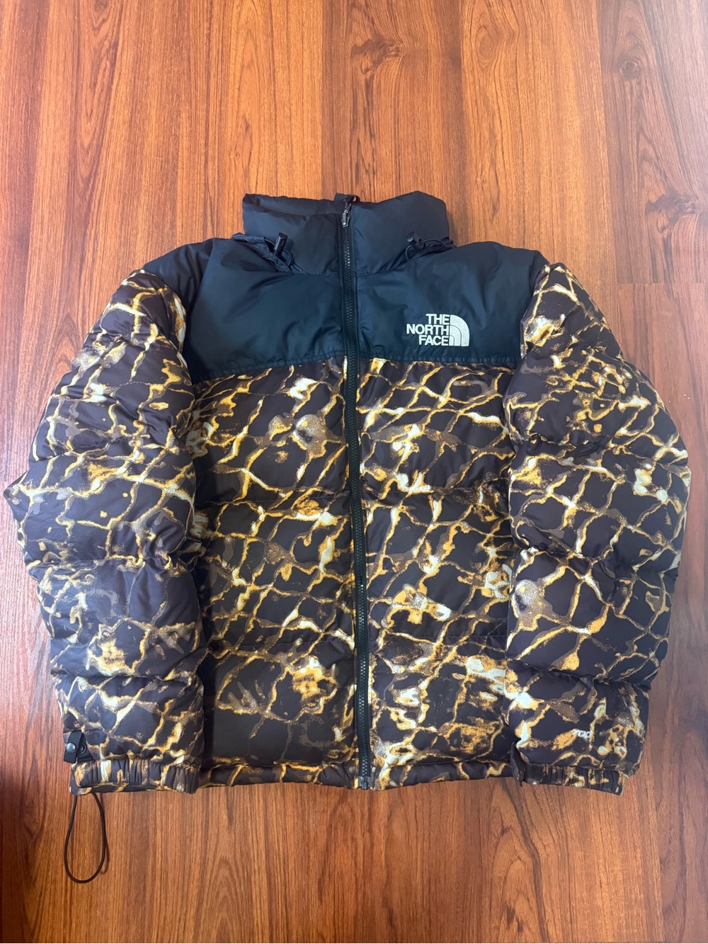The North Face Puffer Jacket in Black & Gold Marble Print
